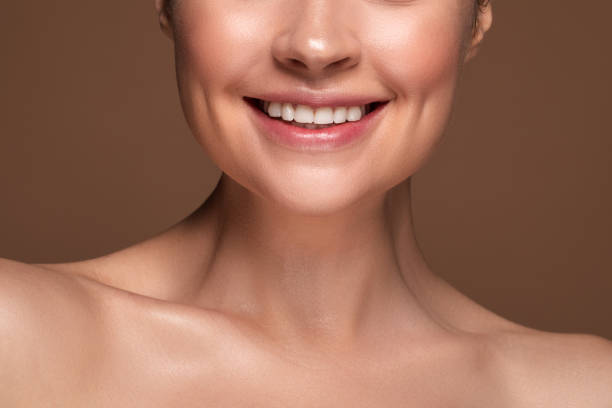 istock Happy woman revealing her white teeth while smiling 1142821457