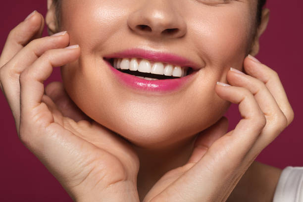 istock Happy woman smiling and touching face with two hands 1142821508