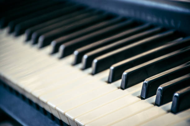 istock Piano keyboard with selective focus. Side view of piano keys 1142821938