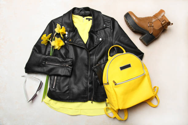 istock yellow backpack with black leather jacket, sunglasses and spring boots 1142822789