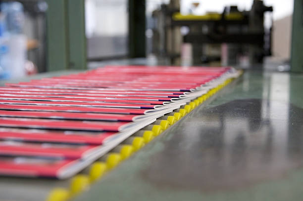 Printing press machine printing broadsheet newspapers in a printing plant.