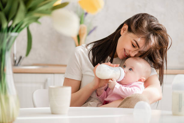 istock Feeding newborn girl with formula in a bottle. 1142823224