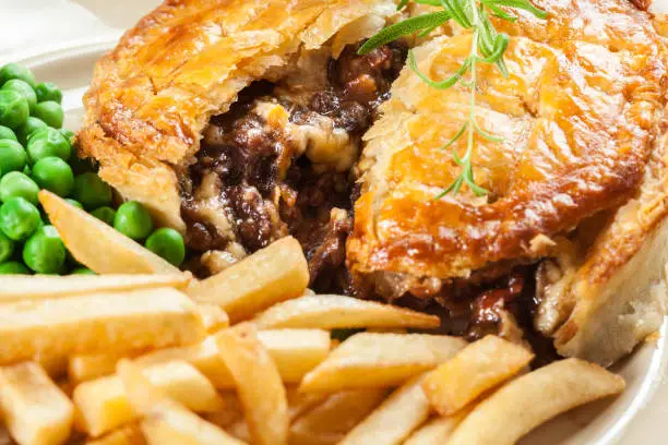 Homemade beef stew pie with french fries. Meat in puff pastry