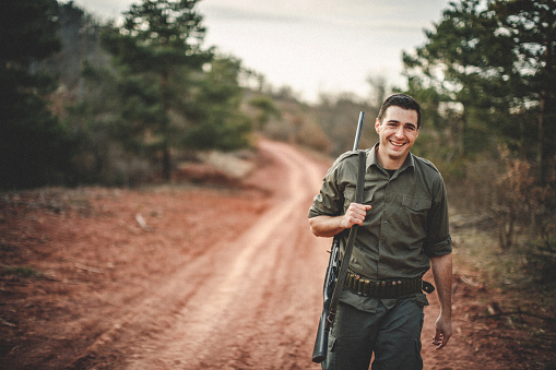 Man holding gun and leading