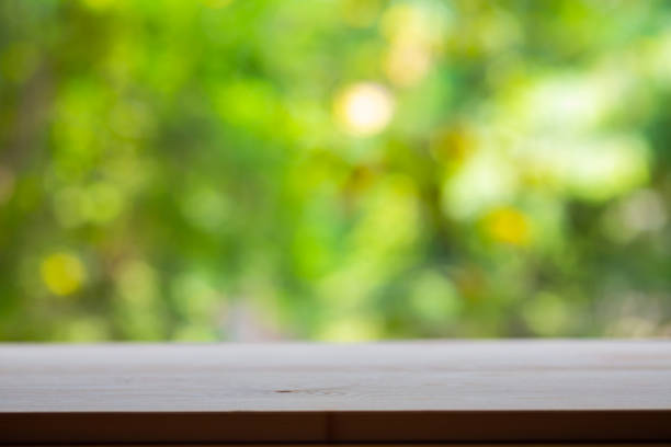 istock Empty wooden table texture, Green garden blurred bokeh background, Selective focus 1142828109