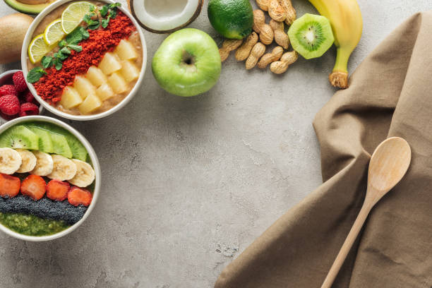 istock top view of smoothie bowls with ingredients and tablecloth on grey background 1142828404