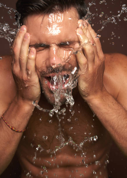 istock Close up young manful guy washing face 1142828504