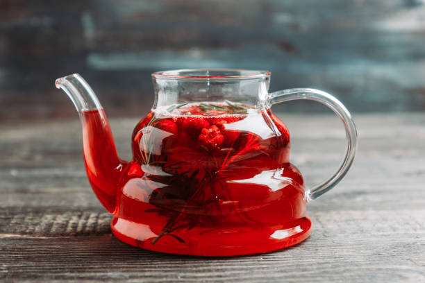 istock Hot raspberry beverage with rosemary in glass teapot 1142828729
