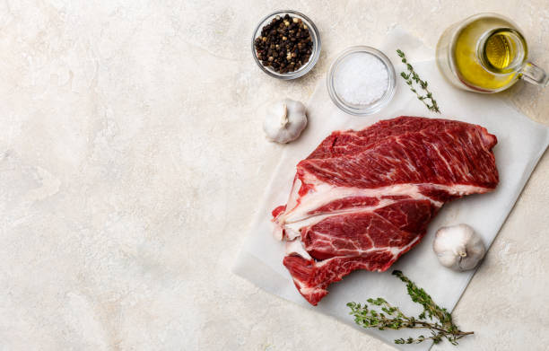 istock Fresh beef meat on white background with olive oil, herbs and spices 1142829664
