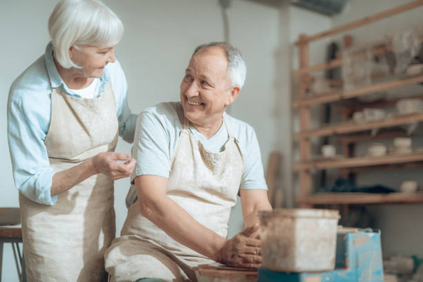 istock Mature clay masters enjoying of chat with each other in potter's studio 1142831442