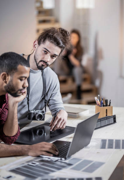 istock Small Group of Photographers Working in The Studio 1142831471