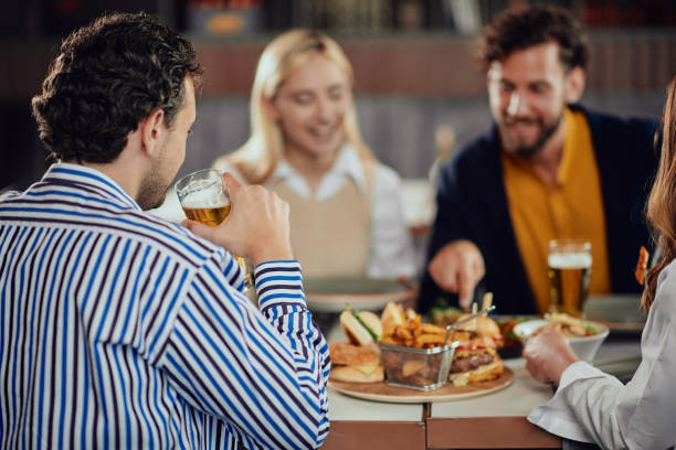 istock Multiethnic friends having dinner at restaurant. 1142831616