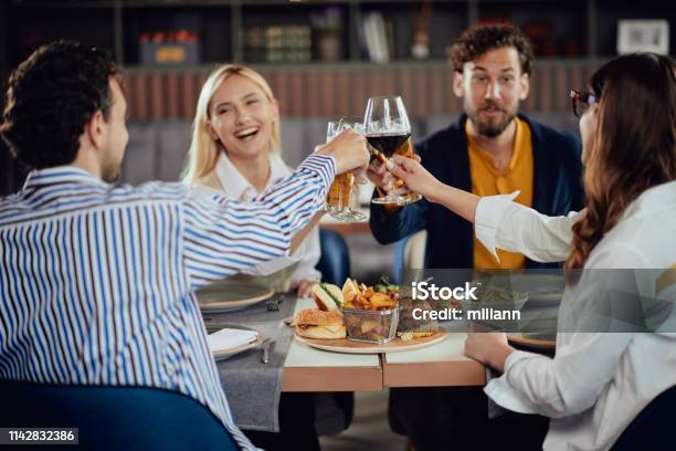 Friends Making A Toast In Restaurant Stock Photo - Download Image Now - Beer - Alcohol, Restaurant, Wine