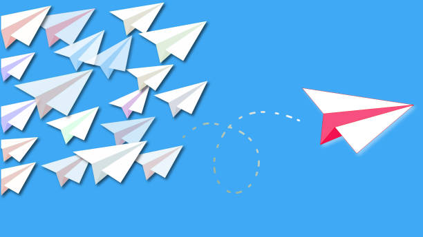istock Smart red paper plane leaves the flock to achieve success 1142832465