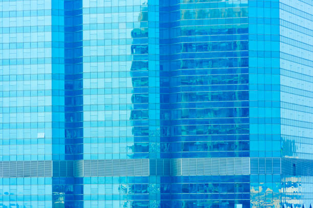 istock Abstract background from blue glasses window on modern building with reflection of blue sky. 1142832665