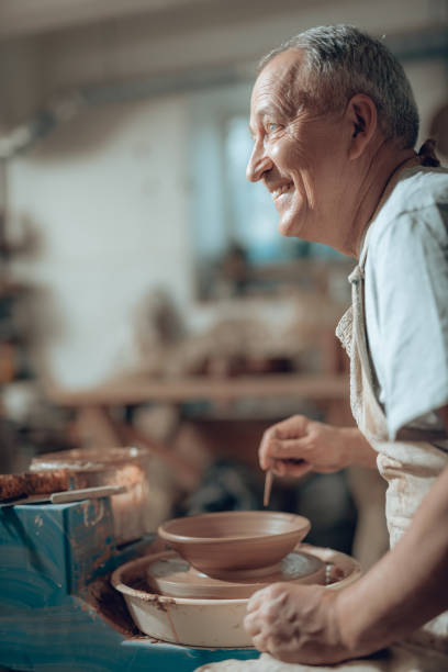 istock Side view of Caucasian craftsman working in potter's studio 1142834309