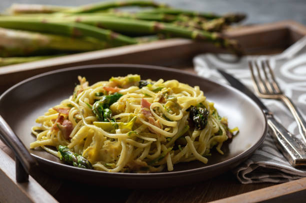 istock Homemade pasta with bacon, parmesan and asparagus. 1142836868