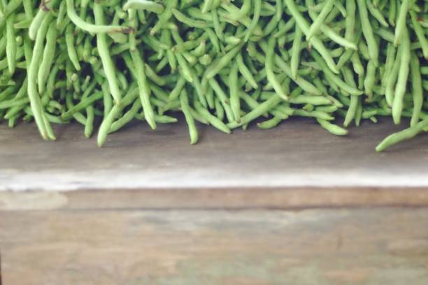 Lots of fresh long bean paste on the old wooden table background.