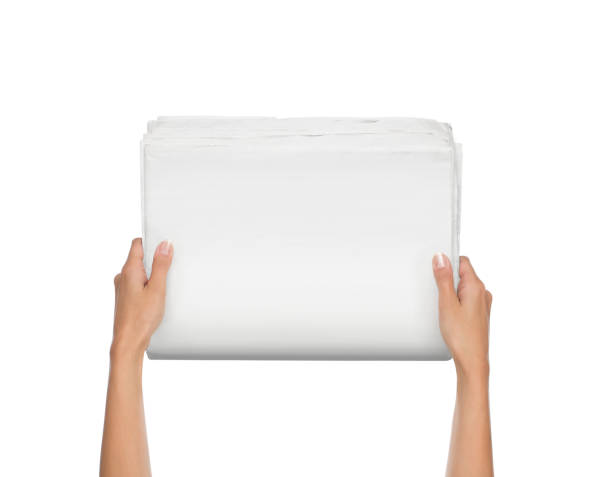 Hands holding blank newspaper isolated on white