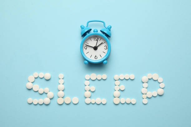istock Sleeping pills and an alarm clock, insomnia concept. Trouble falling asleep 1142840476