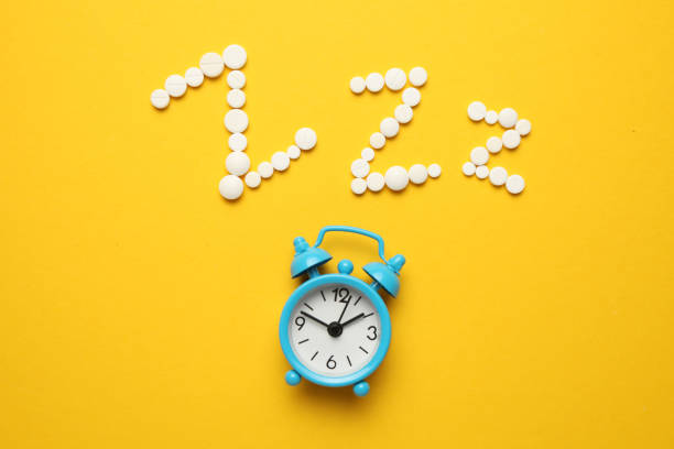 istock Sleeping pills and an alarm clock, insomnia concept. Stress and sleep problems 1142840480