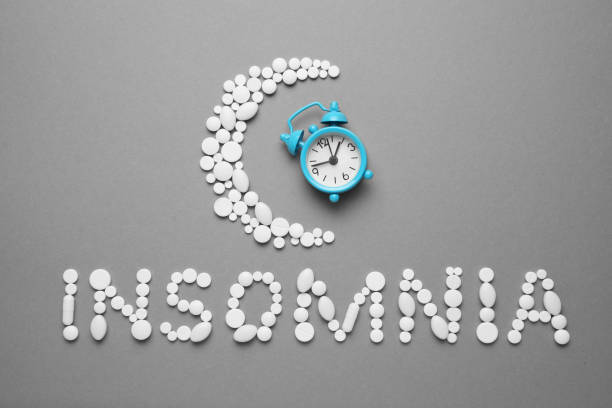 istock Sleeping pills and an alarm clock, insomnia concept. Nightmares and sleep disturbance 1142840487
