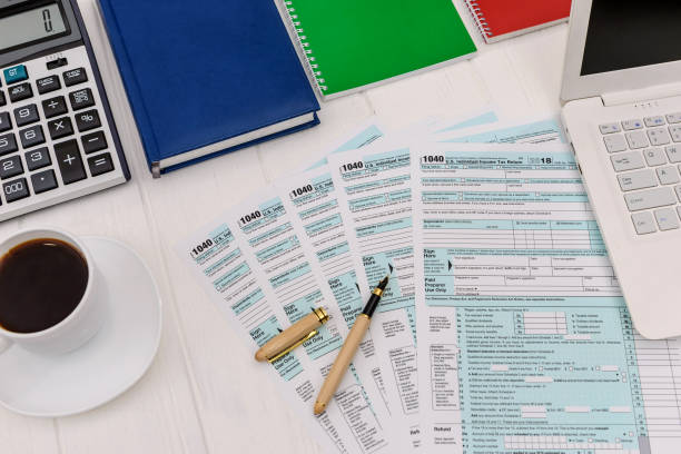 istock 1040 form with notepads, laptop and cup of coffee 1142841372