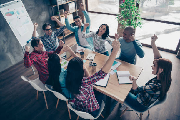 istock Above high angle view of nice attractive beautiful handsome cheerful executive managers wearing casual sitting rejoice at industrial loft interior workplace workstation open space indoors 1142841599