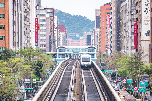 Taipei, Taiwan - April 13, 2019 : Taipei Metro Wenhu Line (Known as The Muzha Line Before Oct, 8, 2009). The Train Runs on Elevated Rails While Other Cars Jammed on The Roads.