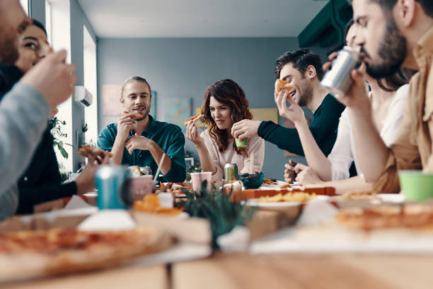 istock Enjoying pizza with friends. 1142843075