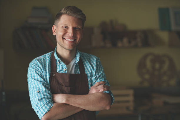 istock Young master in an apron in carpentry 1142844767