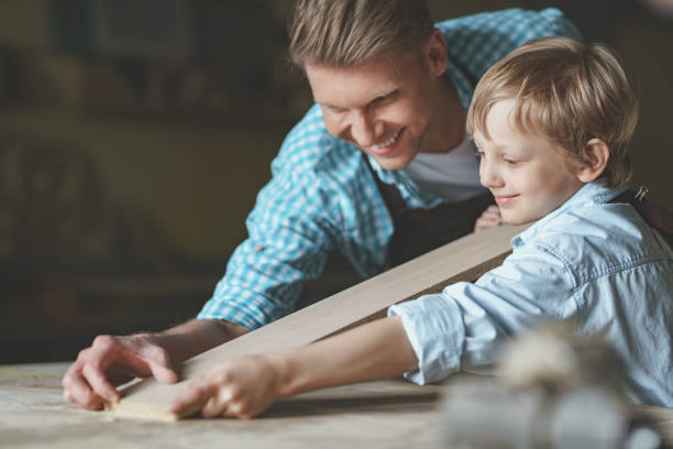istock Smiling father and son with a board 1142844993