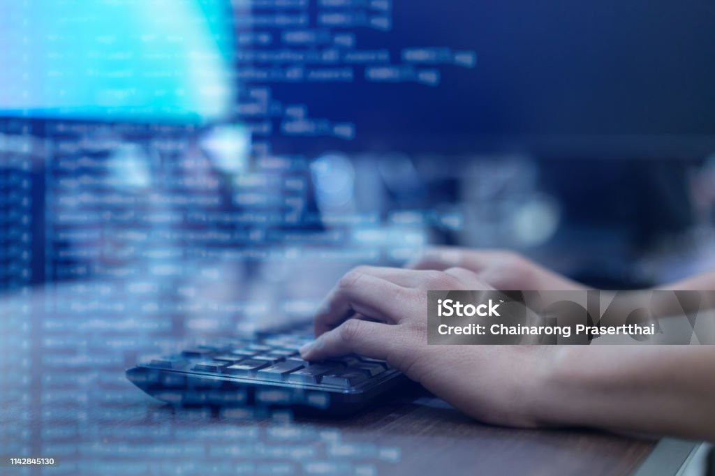 close up programmer man hand typing on keyboard at computer desktop for input coding language to software for fix bug and defect of system in operation room , technology concept Technology Stock Photo