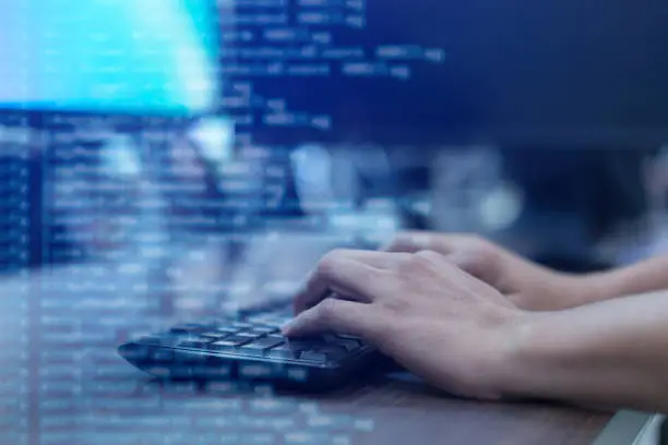 Photo of close up programmer man hand typing on keyboard at computer desktop for input coding language to software for fix bug and defect of system in operation room , technology concept