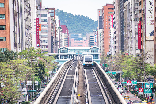 Taipei, Taiwan - April 13, 2019 : Taipei Metro Wenhu Line (Known as The Muzha Line Before Oct, 8, 2009). The Train Runs on Elevated Rails While Other Cars Jammed on The Roads.