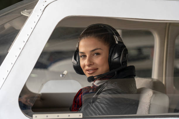 istock Young Woman Pilot With Headset Looking Through The Cockpit Window 1142846197