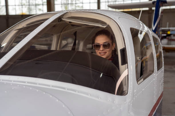 istock Beautiful Young Woman Pilot Looking Through The Cockpit Window 1142846201