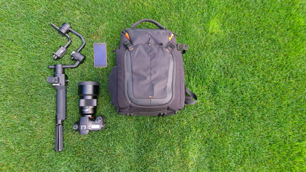 istock Camera and video equipment flat lay on grass 1142846226