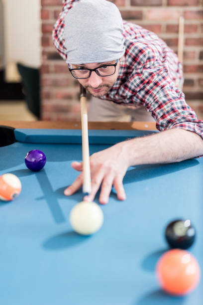 istock Portrait of hipster man playing billiards. 1142846520