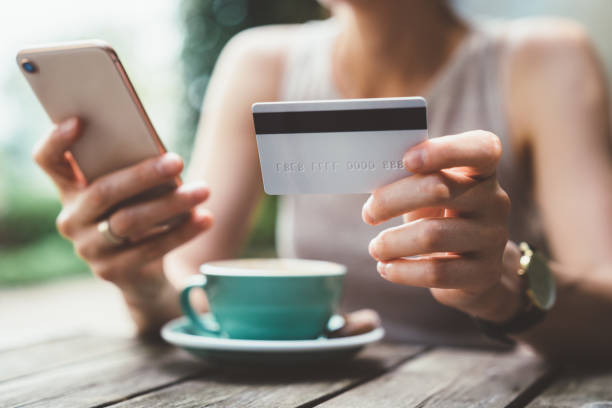 istock Woman using credit card for online payments 1142847342