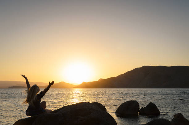 istock Watching the sunset by the sea 1142847710
