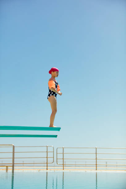 istock Girl learning to dive into the pool 1142849729