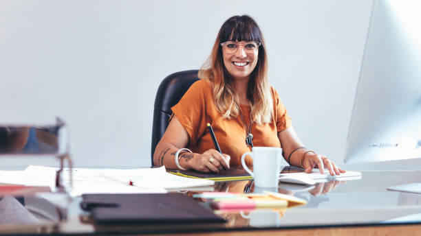 istock Creative artist at work sitting at her desk 1142851611