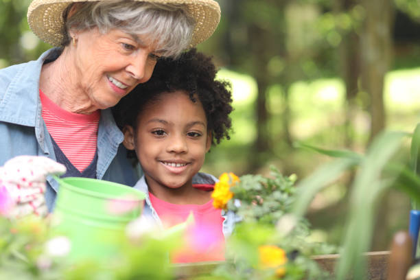 istock Grandmother and child gardening outdoors in spring. 1142855894