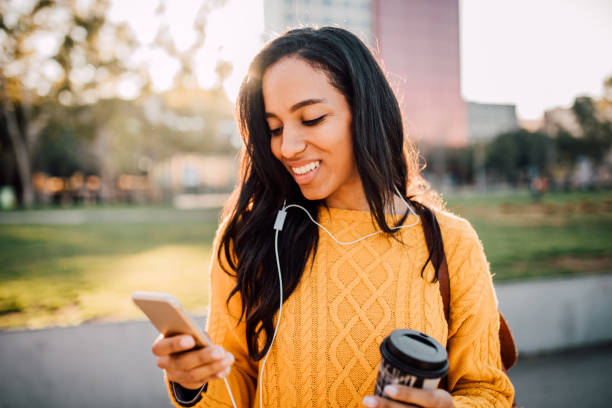 mensajería de texto mujer feliz - city street audio fotografías e imágenes de stock