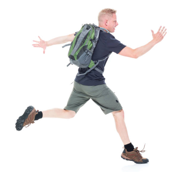 istock Attractive young male hiker running and jumping 1142857734