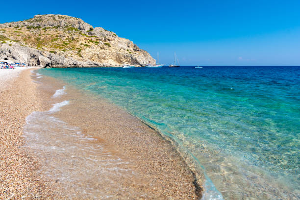 view on Afandou Beach on Rhodes island in Greece crystal clear water of mediterranean sea on Rhodes island afandou stock pictures, royalty-free photos & images