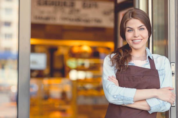 istock Smiling owner in uniform in the bakery 1142858590