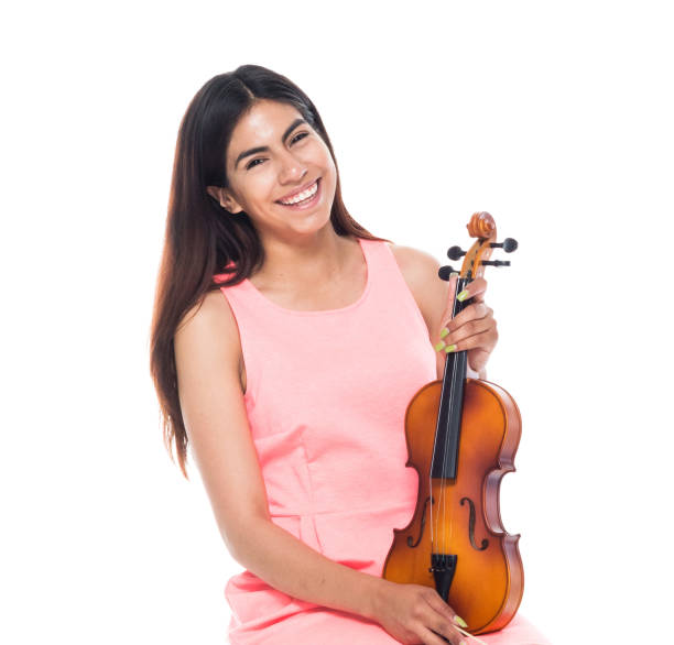 istock Cute female playing the voilin while sitting 1142858751