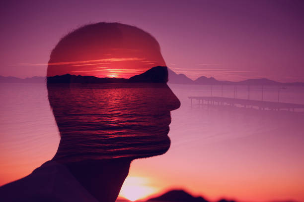 istock Silhouette young man on background of sunset over the sea. Multiple exposure. Creative ideas, peace emotions, abstract thinking concept. 1142858761
